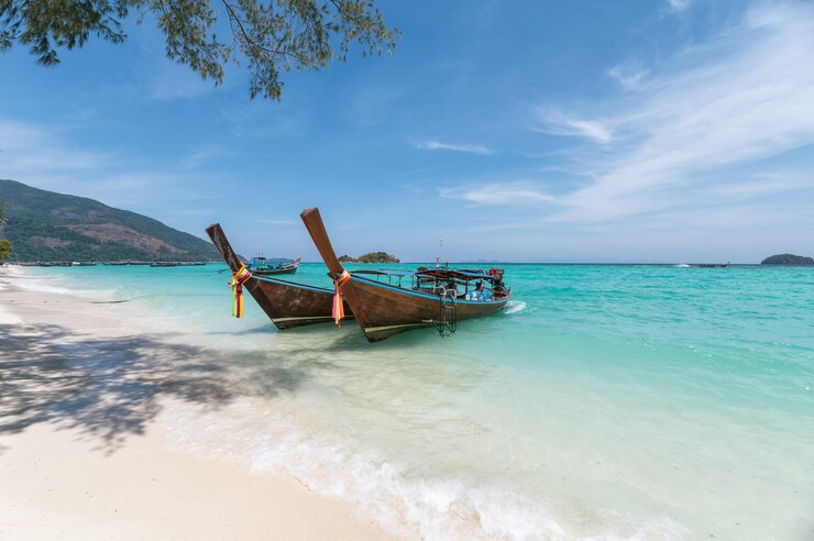 Wooden long-tail boats on crystal tropical Andaman Sea Phuket Phuket