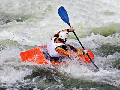 active-male-kayaker-rolling-surfing-rough-water