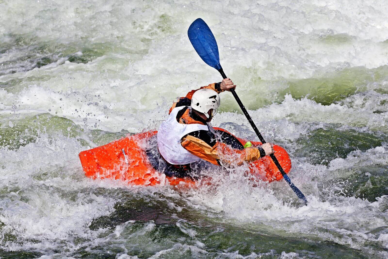 active-male-kayaker-rolling-surfing-rough-water