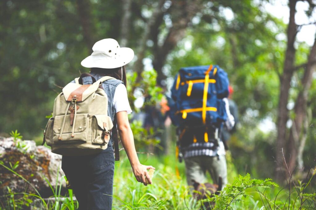 happy-hiker-walks-through-jungle-with-backpack