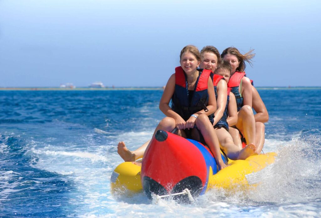 people-ride-banana-boat-bright-blue-sea-clear-sky-happy-vacation