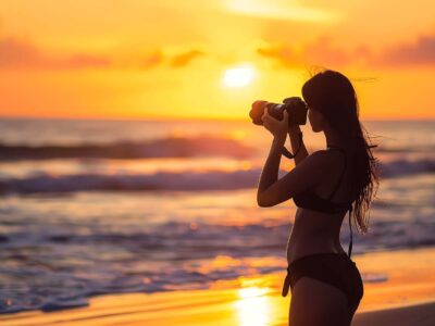 young-woman-bikini-standing-beach-sunset-with-her-camera-she-is-looking-view-taking-pictures