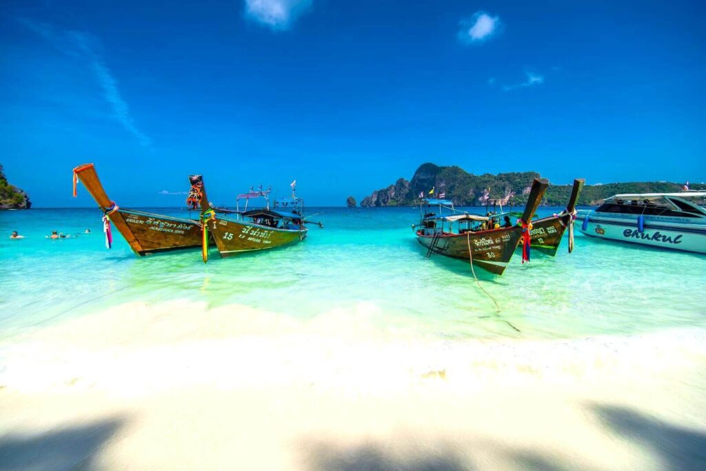 long-tail-boats-parking-white-white-sand-beach-phi-phi-island-thailand