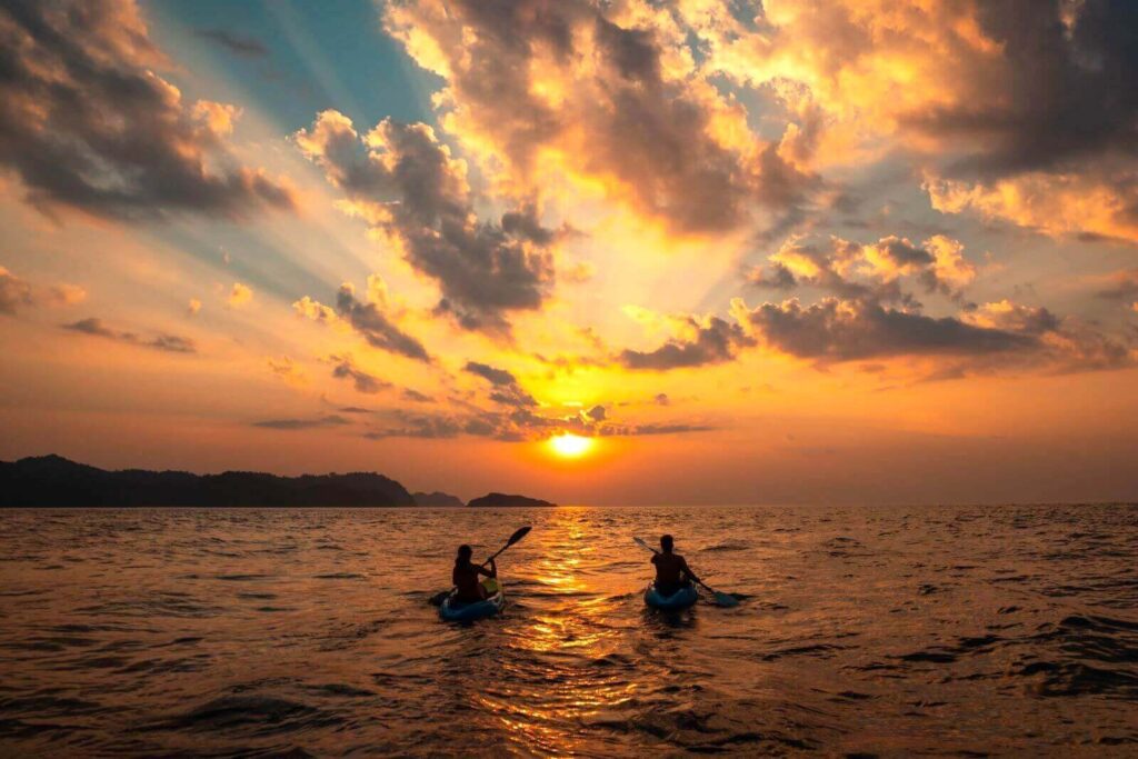 female-male-sailing-with-canoes-close-each-other-sunset-phang-nga-bay-thailand