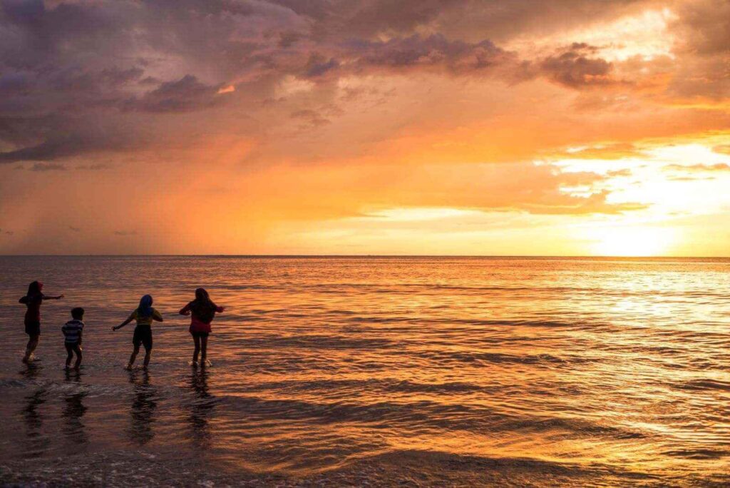 silhouette-woman-kids-play-sunset-beach-andaman-sea-coast-trang-thailand